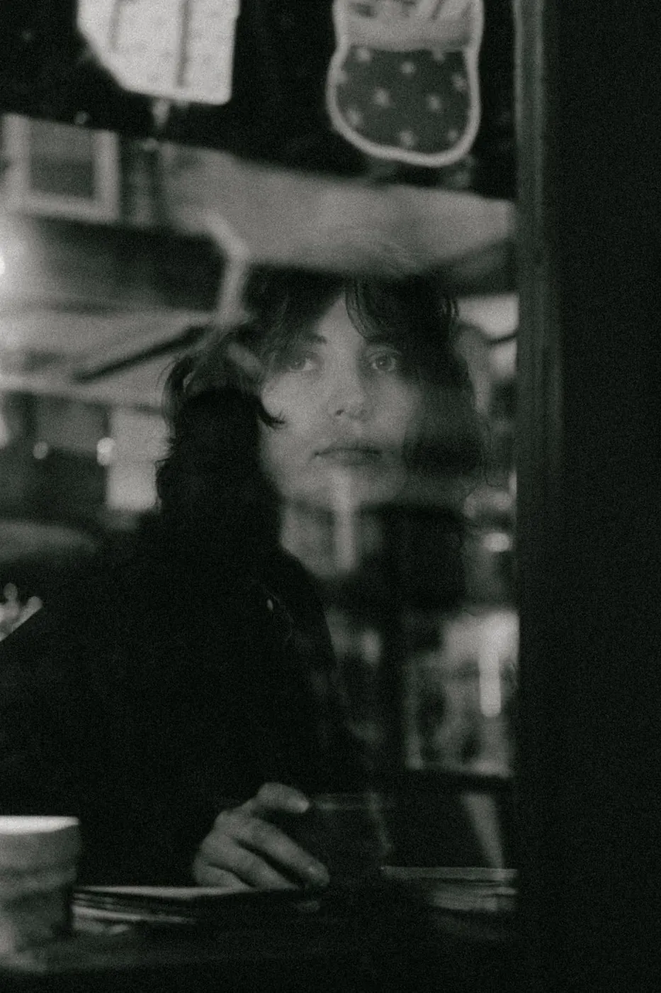 Reflective black and white portrait with mysterious mood.